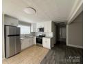 Bright kitchen featuring stainless steel appliances and abundant cabinet space at 1408 Linwood Rd, Gastonia, NC 28052