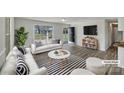 Bright, staged living room with striped accents and a large window at 206 Oshea Ave, Gastonia, NC 28056