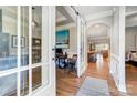 Inviting hallway with hardwood floors, leading to an office and open-concept living space at 215 Wesley Manor Dr, Matthews, NC 28104