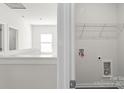 Bright laundry area with wire shelf storage solutions near the staircase at 2223 Catawba Trace Dr, Catawba, NC 28609