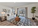 Cozy living room with sliding glass doors, a white sofa, stylish rug, and an abundance of natural light at 2610 Greenmarket Dr, Charlotte, NC 28217