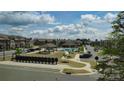 A Primary planned community features a swimming pool, clubhouse, gazebo, and townhomes under a partly cloudy sky at 2635 Winter Thistle Way, Indian Land, SC 29707
