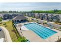 Community pool view with seating and covered pavilion, with neighborhood townhomes in the background at 2635 Winter Thistle Way, Indian Land, SC 29707