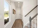 Welcoming entryway featuring a staircase, modern lighting, wood floors, and neutral wall color at 313 Alden Ct, Shelby, NC 28152