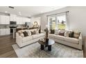 Open-concept living room with comfortable seating, natural light, and seamless flow to the kitchen at 313 Alden Ct, Shelby, NC 28152