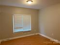 Cozy bedroom featuring neutral walls, wood floors, and a window for natural light at 3195 Reservation Rd, Rock Hill, SC 29730