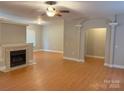Open concept living room with a classic fireplace, hardwood floors, and large windows for natural light at 3195 Reservation Rd, Rock Hill, SC 29730