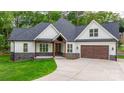 Charming new construction with a white facade, dark roof, stone accents, and a covered porch at 3732 Whitney Ne Dr, Hickory, NC 28601