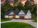 Stunning two-story home featuring a welcoming front porch, attached garage, and lush green lawn at 3732 Whitney Ne Dr, Hickory, NC 28601