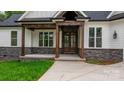 Inviting front entrance with stone accents and a stylish, covered entryway, great curb appeal at 3732 Whitney Ne Dr, Hickory, NC 28601