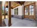 Close-up of the front door of a home showcasing a stylish covered entryway with custom stonework at 3732 Whitney Ne Dr, Hickory, NC 28601