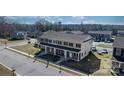 Aerial view of townhouses featuring covered porches, landscaped yards, and community streetscape at 3931 Newhall Nw Dr, Hickory, NC 28601