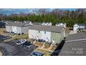 Exterior view of townhouses showcasing siding, parking areas, and landscaped grounds at 3931 Newhall Nw Dr, Hickory, NC 28601