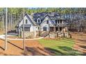 Beautiful exterior of a home with stone accents, a covered front porch and meticulous landscaping at 4354 Persimmon Rd, Lancaster, SC 29720