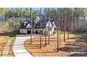 Exterior view showing the light home with a side entry garage and long drive at 4354 Persimmon Rd, Lancaster, SC 29720