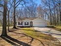 Exterior of a cute one story house with a garage and a shady yard at 4901 Sandstone Ln, Monroe, NC 28110