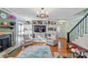 Spacious living room featuring a fireplace, hardwood floors and custom built-in shelving at 5053 Marci Ln, Belmont, NC 28012