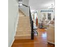 Bright living room featuring hardwood floors, staircase with iron railing and plenty of natural light at 5053 Marci Ln, Belmont, NC 28012