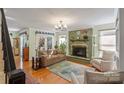 Inviting living room featuring a fireplace, hardwood floors and doors leading to the outside at 5053 Marci Ln, Belmont, NC 28012