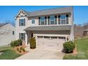 Charming two-story home with a well-manicured lawn and a two-car garage at 7217 Kenyon Dr, Denver, NC 28037