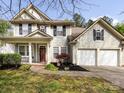 Charming two-story home with a well-manicured lawn, a two-car garage, and lovely front porch at 8830 Beaver Creek Dr, Charlotte, NC 28269