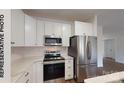 Eat-in kitchen featuring white cabinets and stainless appliances at 917 Moose St, Gastonia, NC 28056