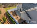 A fenced backyard featuring a paved patio, and neatly trimmed hedges, providing a private outdoor space at 1005 Headwaters Ct, Matthews, NC 28104