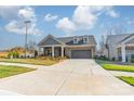 Beautiful home with a two-car garage, manicured lawn, and classic architectural details at 1005 Headwaters Ct, Matthews, NC 28104