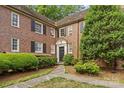 Brick exterior of the home with black shutters and neatly trimmed landscaping at 108 Colville Rd # 21B, Charlotte, NC 28207