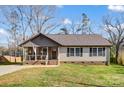 Inviting home featuring a covered porch with seating and a well-maintained front yard at 124 Washington St, York, SC 29745