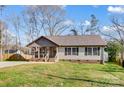 Lovely home with a welcoming front porch, a manicured lawn, and a peaceful neighborhood setting at 124 Washington St, York, SC 29745