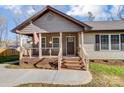 Inviting front porch with a patriotic flag, decorative plants, and comfortable seating at 124 Washington St, York, SC 29745