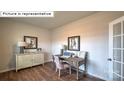 Inviting home office featuring hardwood floors, a modern desk setup, and ample natural light at 1325 Secrest Commons Dr, Monroe, NC 28112