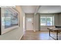 Inviting foyer with hardwood floors, white front door, neutral paint, and lots of natural light from surrounding windows at 1353 Secrest Commons Dr, Monroe, NC 28112