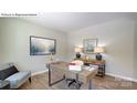 Well-lit home office with sleek desk, chair, wood floors, gray walls, and minimalist decor at 1353 Secrest Commons Dr, Monroe, NC 28112