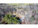 Aerial view of property featuring home, barn, surrounded by lush forestry at 1366 Vashti Rd, Taylorsville, NC 28681