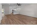 Open-concept living area with modern lighting and hardwood floors seamlessly connected to the stylish kitchen at 140 Swimmers Ln, Salisbury, NC 28146
