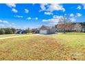 View of backyard with mature trees, a well-manicured lawn, and a view of the house at 1429 Scotts Creek Rd, Statesville, NC 28625