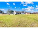 Inviting single-story home nestled on a spacious lot, showcasing a well-maintained lawn and classic design at 1429 Scotts Creek Rd, Statesville, NC 28625