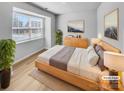 Staged bedroom featuring neutral decor, hardwood floors, and a large window at 151 Slip Shot Ln, Troutman, NC 28166
