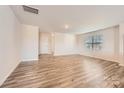 Bright and airy living room with wood-look flooring and abundant natural light streaming through the window at 1825 Broom Maker Dr, Bessemer City, NC 28016