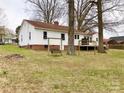 Spacious backyard with mature trees, a wooden swing, and a deck, perfect for outdoor enjoyment at 211 W 1St St, Landis, NC 28088