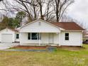 Charming single-story home with a cozy front porch, complemented by well-manicured front lawn at 211 W 1St St, Landis, NC 28088