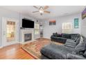 Inviting living room features a fireplace, hardwood floors, and a comfortable gray sectional sofa at 2157 Tommy Ln, Matthews, NC 28105
