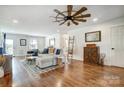 Bright living room with hardwood floors, comfortable seating, and a unique ceiling fan at 276 Rumple Hill Dr, Statesville, NC 28677