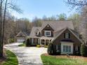Beautiful brick and stone home on a large lot featuring a long driveway and well manicured lawn at 3024 Beaver Dam Dr, Monroe, NC 28110