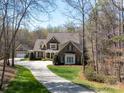Beautiful brick and stone home on a large lot featuring a long driveway and well manicured lawn at 3024 Beaver Dam Dr, Monroe, NC 28110