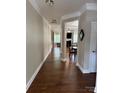 Inviting home hallway featuring elegant trim detail and hardwood flooring, transitioning into the main living area at 3500 Exbury Gardens Dr, Waxhaw, NC 28173