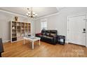 Cozy living room with hardwood floors, large shelving unit and neutral paint at 369 Shoreline Pkwy, Tega Cay, SC 29708