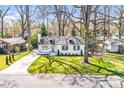 Charming renovated home with a manicured front lawn and mature shade trees at 5009 Milford Rd, Charlotte, NC 28210